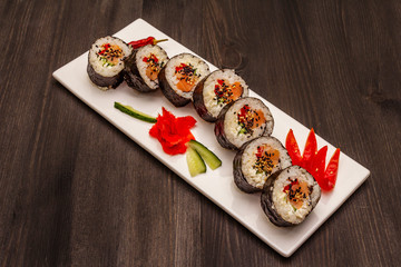 Korean roll Gimbap(kimbob). Steamed white rice (bap) and various other ingredients. Trendy black background