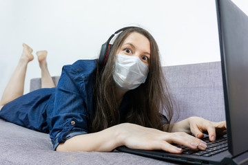 girl student wear headphone study online with video call. woman watch laptop at home. Covid-19 coronavirus.