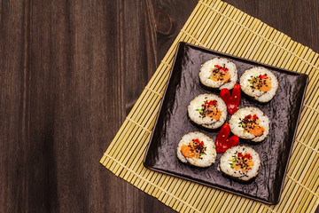 Korean roll Gimbap(kimbob). Steamed white rice (bap) and various other ingredients. Trendy black background