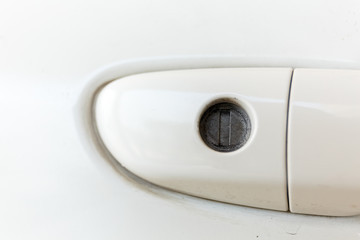 Close up of Dirty white car keyhole.