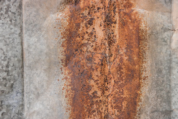 A rust texture pattern on the old zinc sheet background. Close up photo.