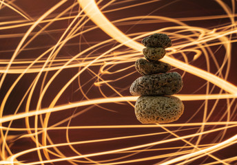 Art-photo. Pyramid of levitating stones on the background of fire. Relax & Meditation.