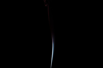 puffs of white smoke with a black background
