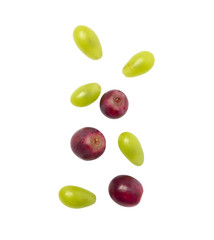 Falling green and red grapes isolated on white background with clipping path.