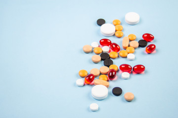 pills of different colors on a blue background 