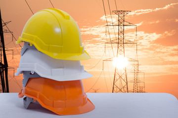 Safety helmet stacked in the background sunset high voltage pole