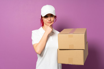 Teenager delivery girl isolated on purple background thinking