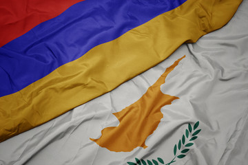 waving colorful flag of cyprus and national flag of armenia.