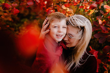 autumn landscape, red and yellow leaves, good sunny weather, family, mom dad and son for a walk, pregnant mother, blonde pregnant girl, joy, happiness, happy family expecting a baby, older brother