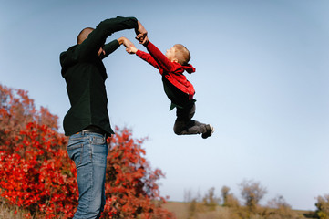 autumn landscape, red and yellow leaves, good sunny weather, family, mom dad and son for a walk,...