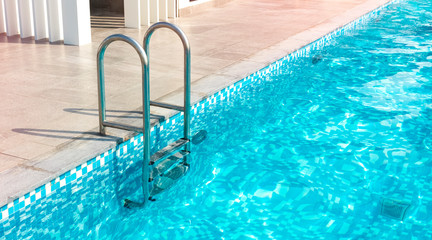 Metal staircase for the pool. The pool of a large house, hotel. Copy space