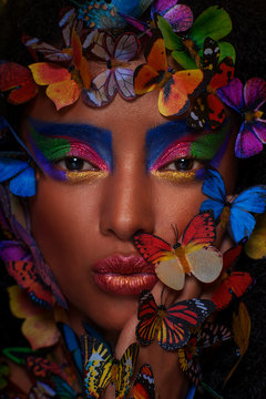 beautiful african girl surrounded by butterflies