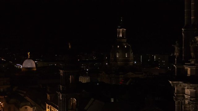 drone flight by night over the historic city of Dresden with the opera house Zwinger and the church dresden kreuzkirche