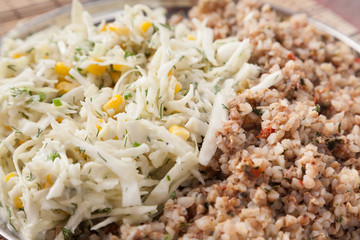 Closeup of buckwheat and fresh cabbage salad with selective focus