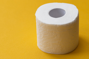 Close-up image of toilet roll isolated on yellow background