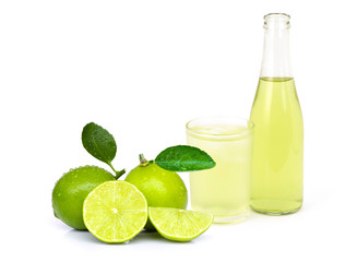glass and bottle of  lime juice with leaf and slice isolated on white background. 