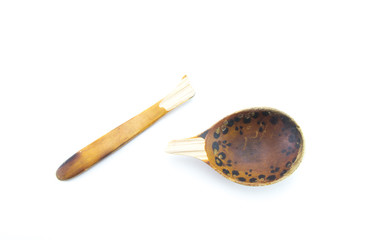Old broken wooden spoon in light brown on a white isolated background.