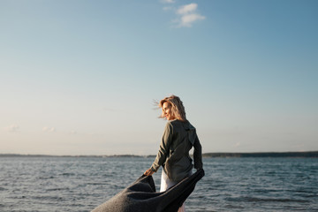 Fototapeta premium woman walks along the beach