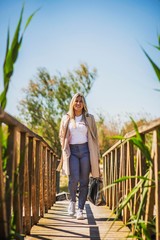 young business woman standing on a bridge