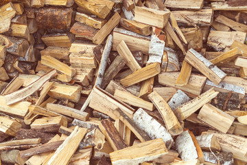 A small pile of chopped birch logs. Background of Birch firewood for the oven.