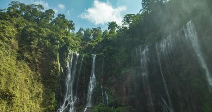 Timelapse of Sewu waterfalls, Java, Indonesia. The camera lens fills with water while a sea of droplets flies through the air, producing a vibrant, lens-blur image.