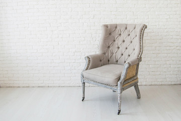 light gray armchair in an empty room