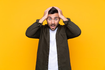 Man over isolated yellow background with surprise facial expression