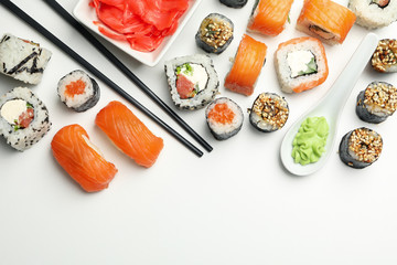 Sushi rolls and chopsticks on white background, space for text. Japanese food