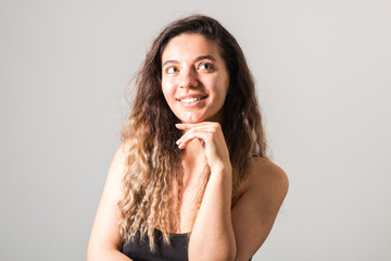 portrait of a young cheerful woman with freckles skin green eyes and curly hairs in black t-shirt smiling. natural beauty and body positive