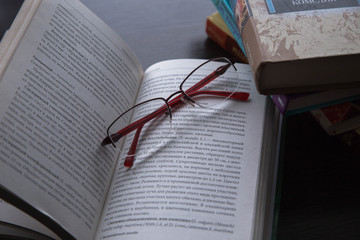 books for reading, lying on the table in a stack and open