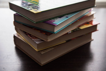 books for reading, lying on the table in a stack and open