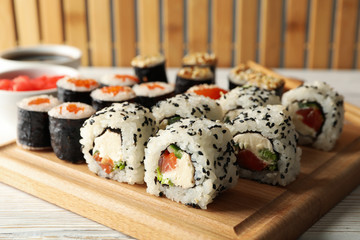 Delicious sushi rolls on wooden background, close up. Japanese food