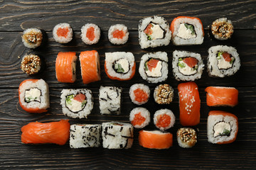 Flat lay with sushi rolls on wooden background. Japanese food