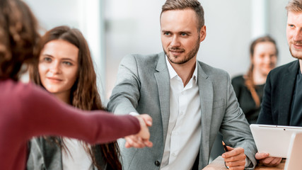 young businessman shaking hands with his business partner