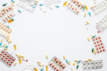 Flu treatment concept with medicine pills on white background top view copy space