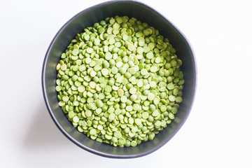 Dried split peas in a black bowl