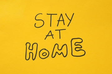 Inscription Stay at home on yellow background. Quarantine