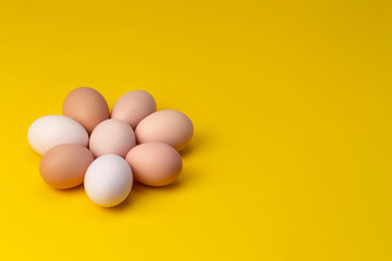 homemade eggs are laid out in the shape of a flower on a yellow background
