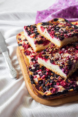 Closeup of berry pie with cottage cheese cut on square slices