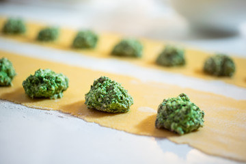 Fresh homemade italian pasta ravioli with ricotta and spinach. The process of cooking.