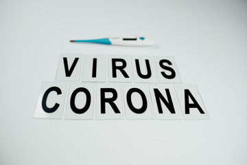 big black words corona virus on white background witn termometer and mask