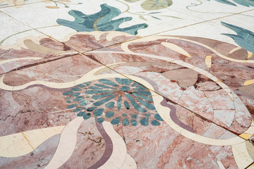 Part of the floor is made of colored marble. Background, texture