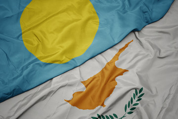 waving colorful flag of cyprus and national flag of Palau .