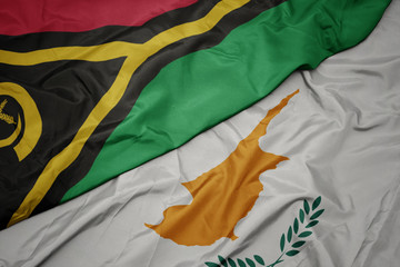 waving colorful flag of cyprus and national flag of Vanuatu .