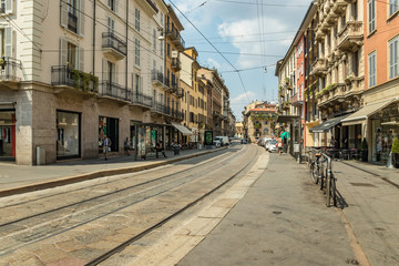 Fototapeta na wymiar MILAN, ITALY - AUGUST 01, 2019: Tourists and locals walk in the center of Milano. Shops, boutiques, cafes and restaurants