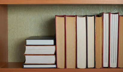 Education learning concept with opening book or textbook in old library, stack piles of literature...