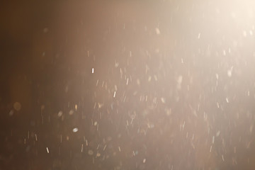 golden colour dust particle on black background
