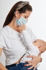 Breastfeeding mother wearing a mask on white background