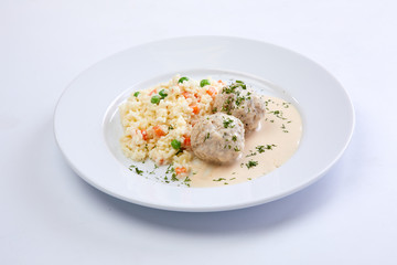 meatballs with rice and vegetables on the white background