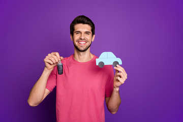 Photo of attractive handsome guy good mood hold paper blue car hands dealer agent offer keys credit percent money wear casual pink t-shirt isolated purple color background